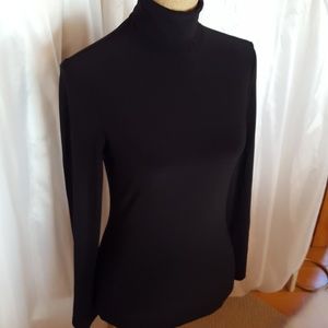 Black form fitting turtleneck.